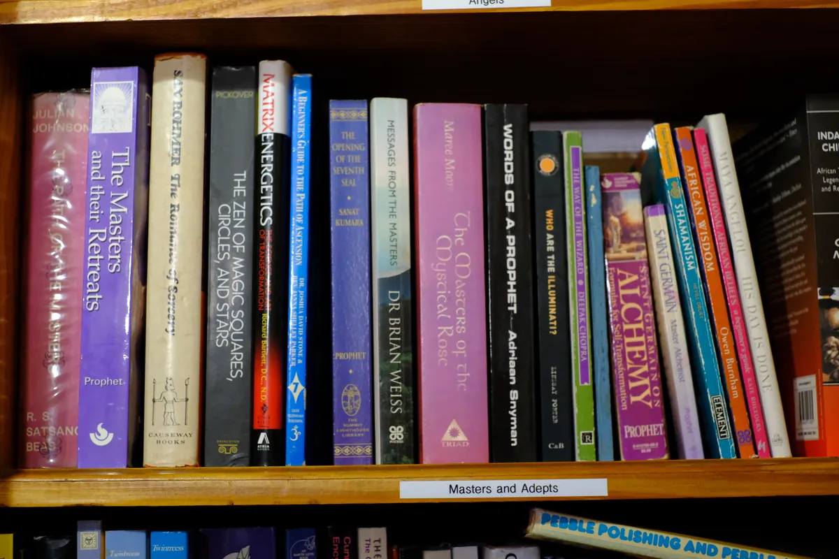 A shelf labelled Masters and Adepts, holding books on prophecy, alchemy and ancient wisdom